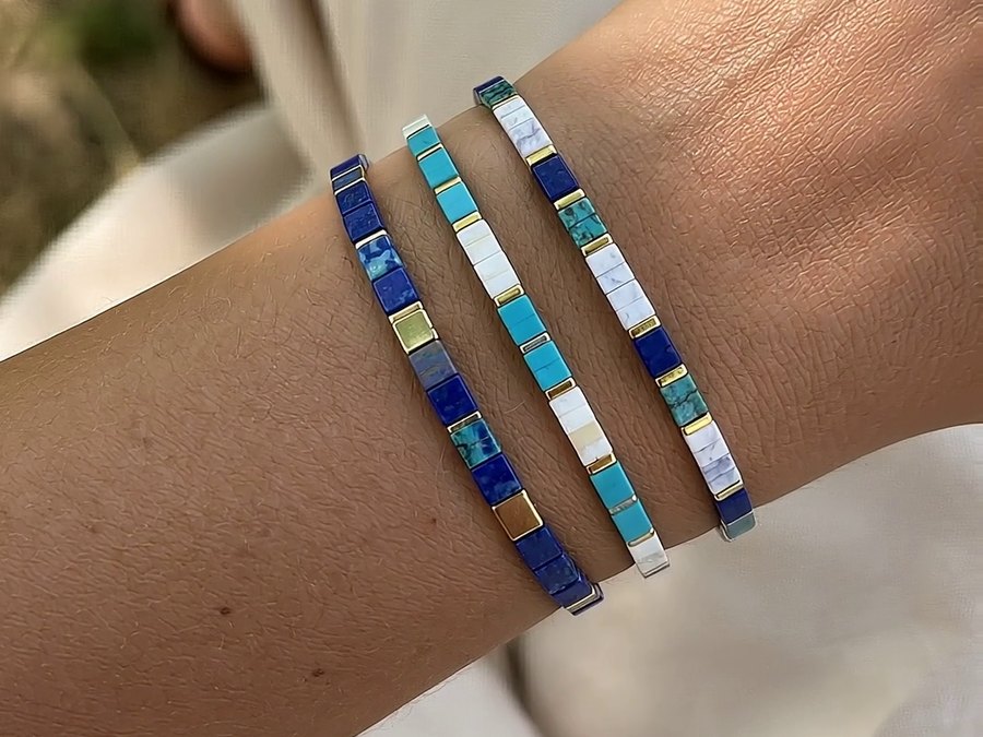 A wrist wearing Rescue Paws Tile bracelets