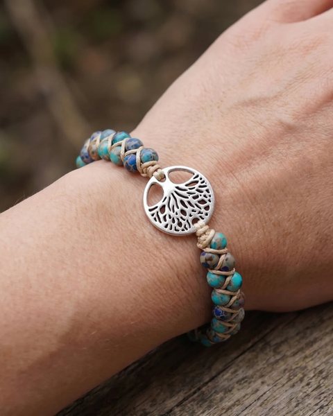 A wrist wearing a Rescue Paws Tree of Life bracelet