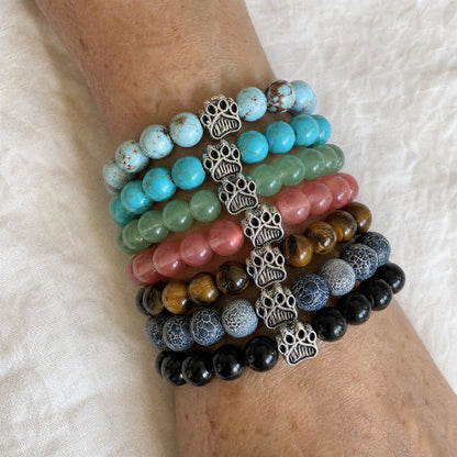 Seven Rescue Paws bracelets from the Bestsellers set stacked and worn on a wrist