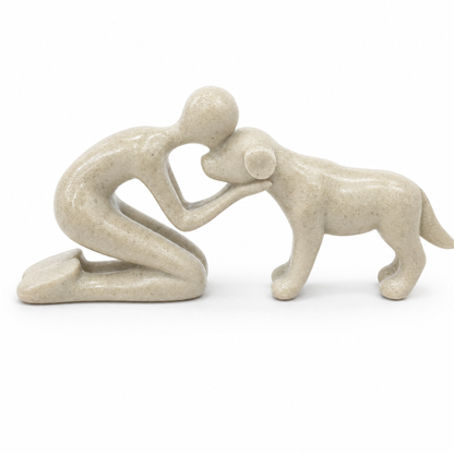 Gentle Moment Statue: a kneeling person hugging a dog, speckled sand finish