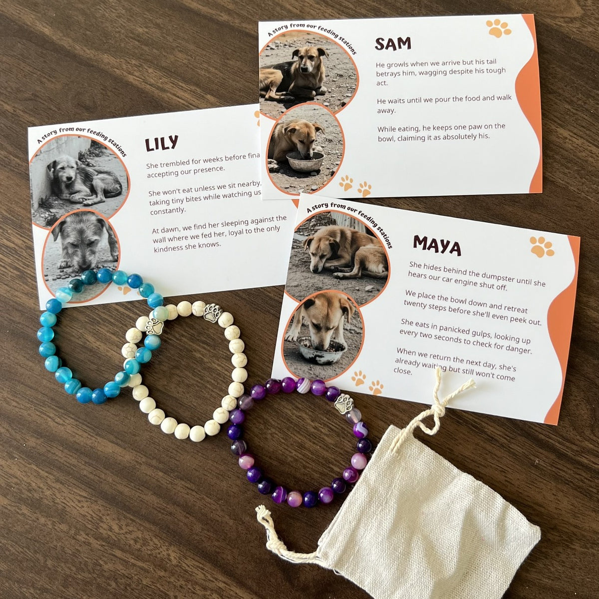 Two Rescue Paws bracelets with their story cards and a cotton pouch