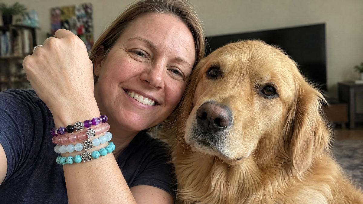 A woman hugging her golden retriever, wearing four Rescue Paws bracelets