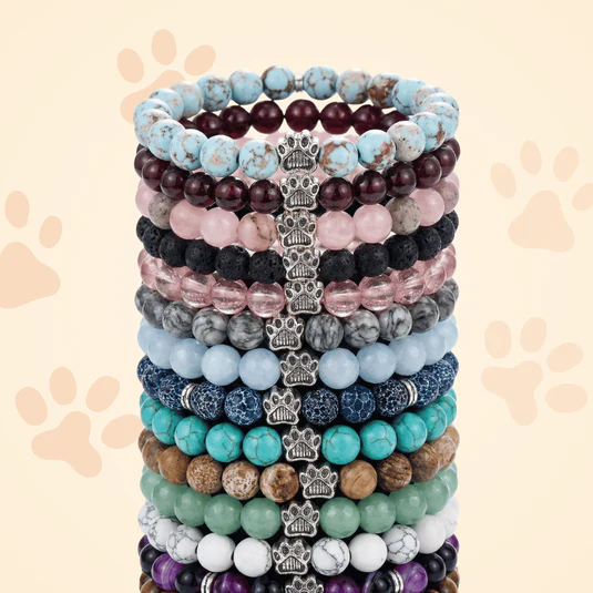 A stack of Rescue Paws bracelets in different colors and natural stones