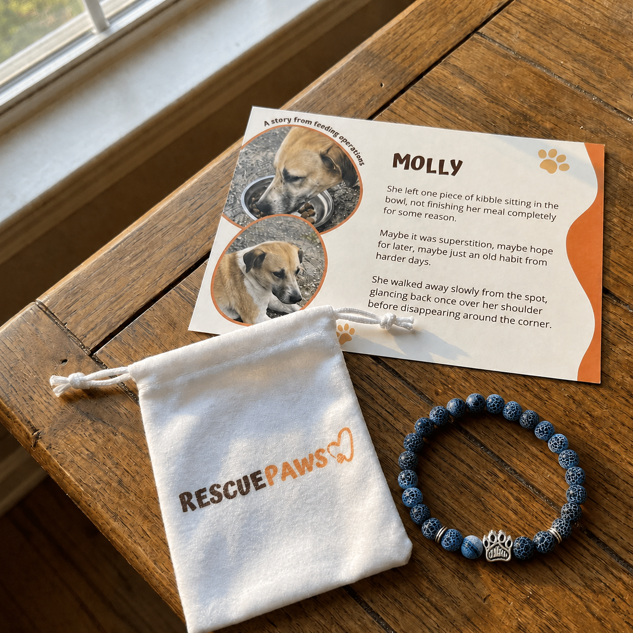 A Rescue Paws bracelet, gift pouch and story card from a feeding operation