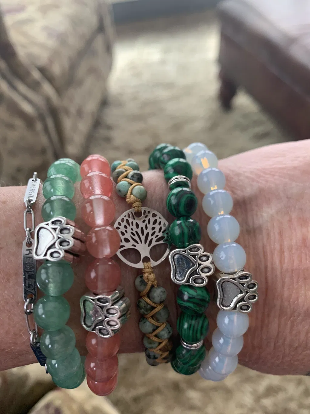 Several colorful Rescue Paws bracelets worn together